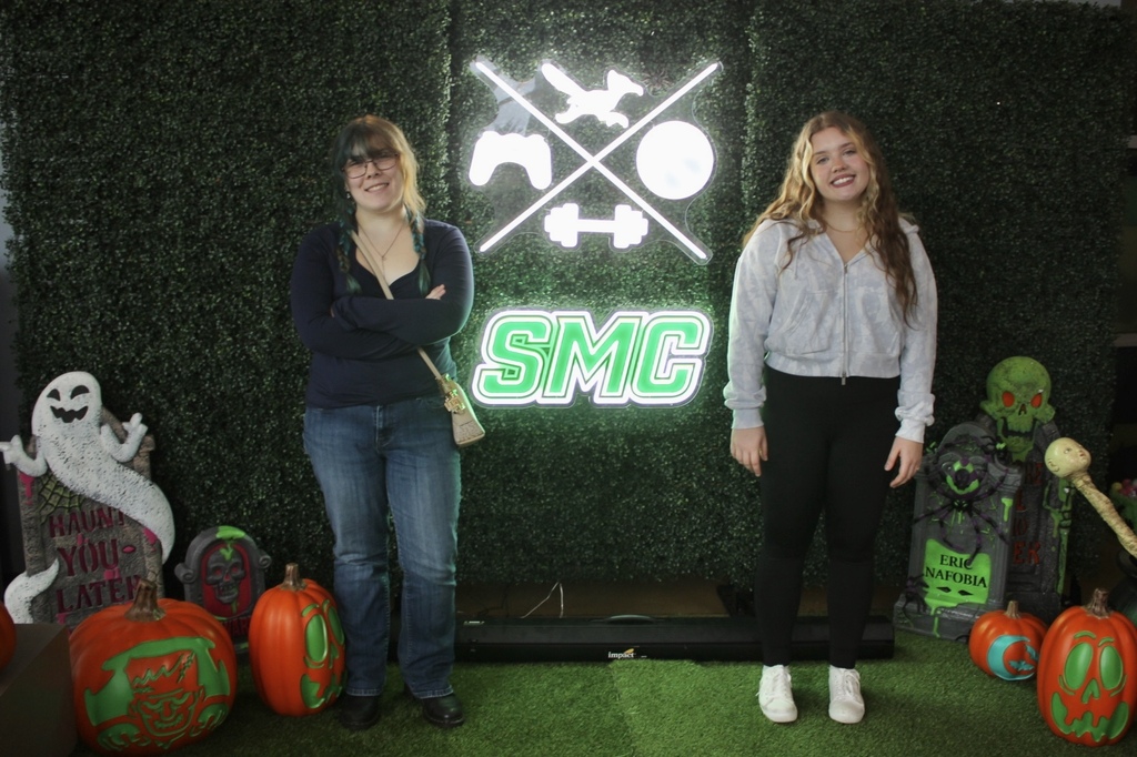two students standing in front of SMC sign 