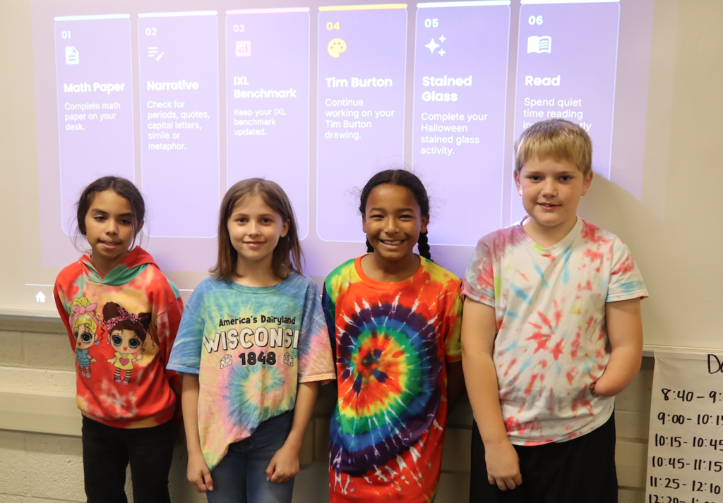 four kids dressed in tie dye