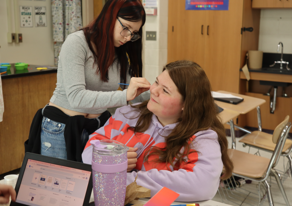 girls painting another girls face