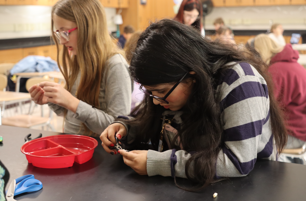 two girls working with beads