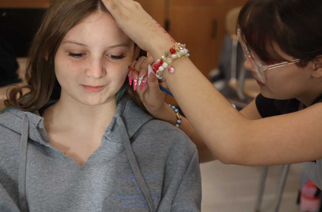 girls painting another girls face