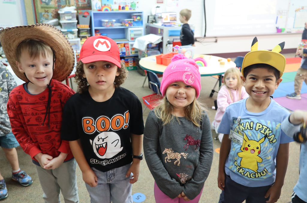 four students with hats on