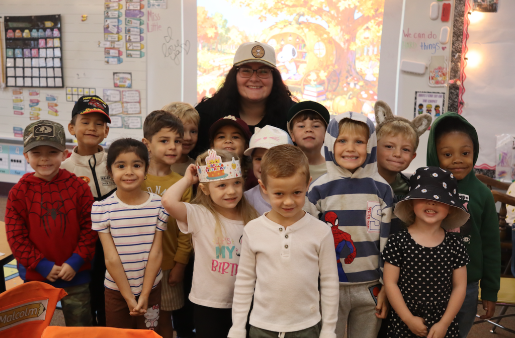 students with teacher and hats on