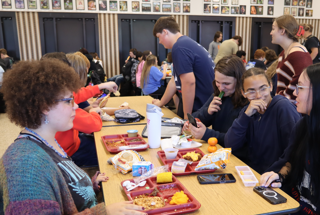 students laughing at table at lunch