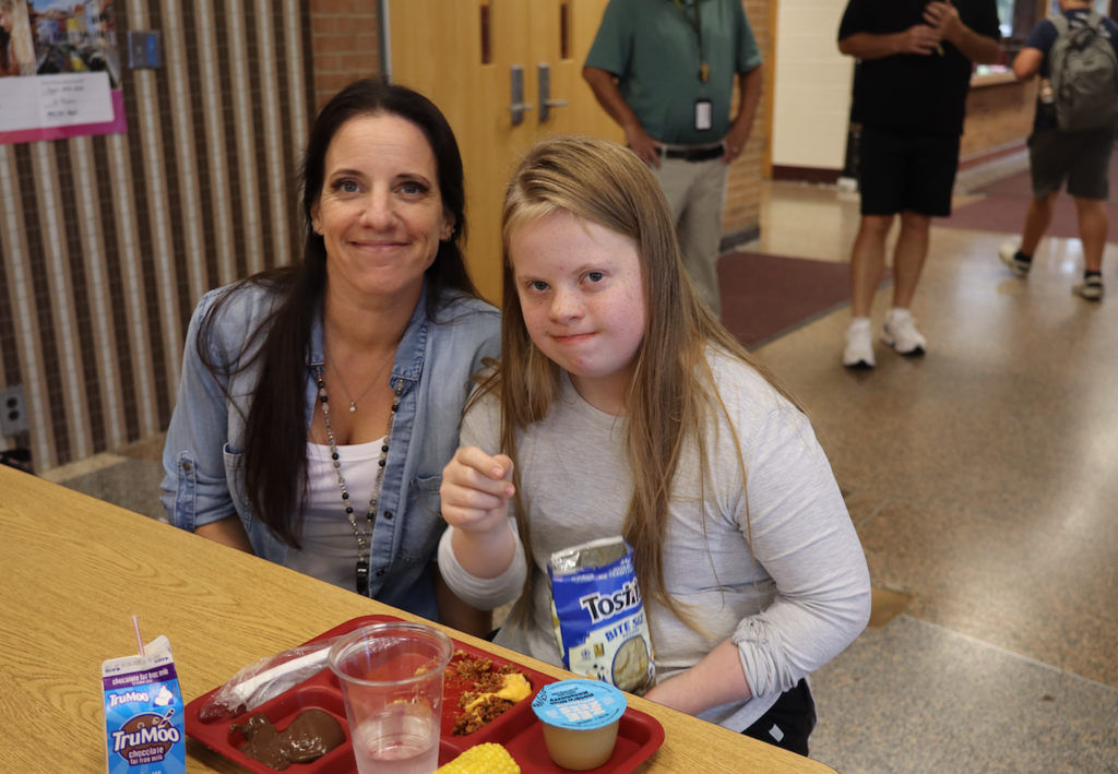 woman sitting with kid at lunch