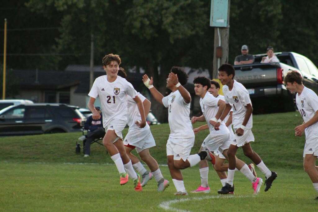 soccer team running on field