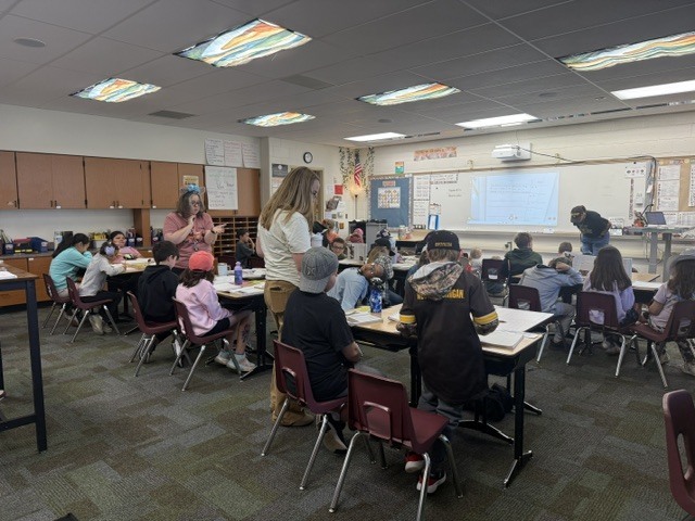 teachers helping students in the classroom