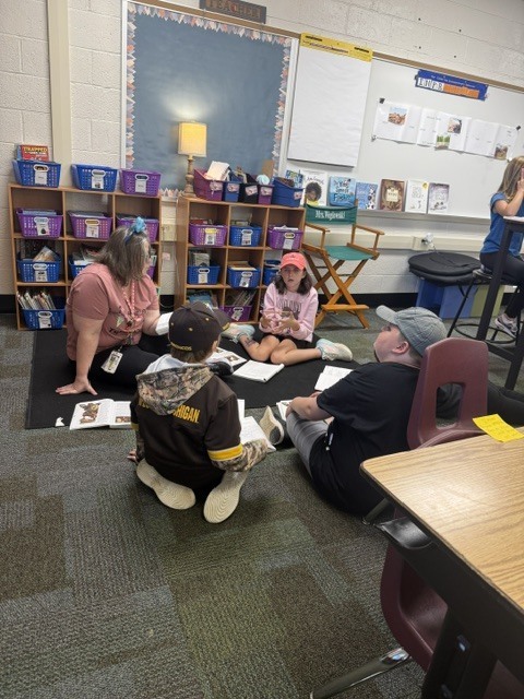 kids on carpet with teacher