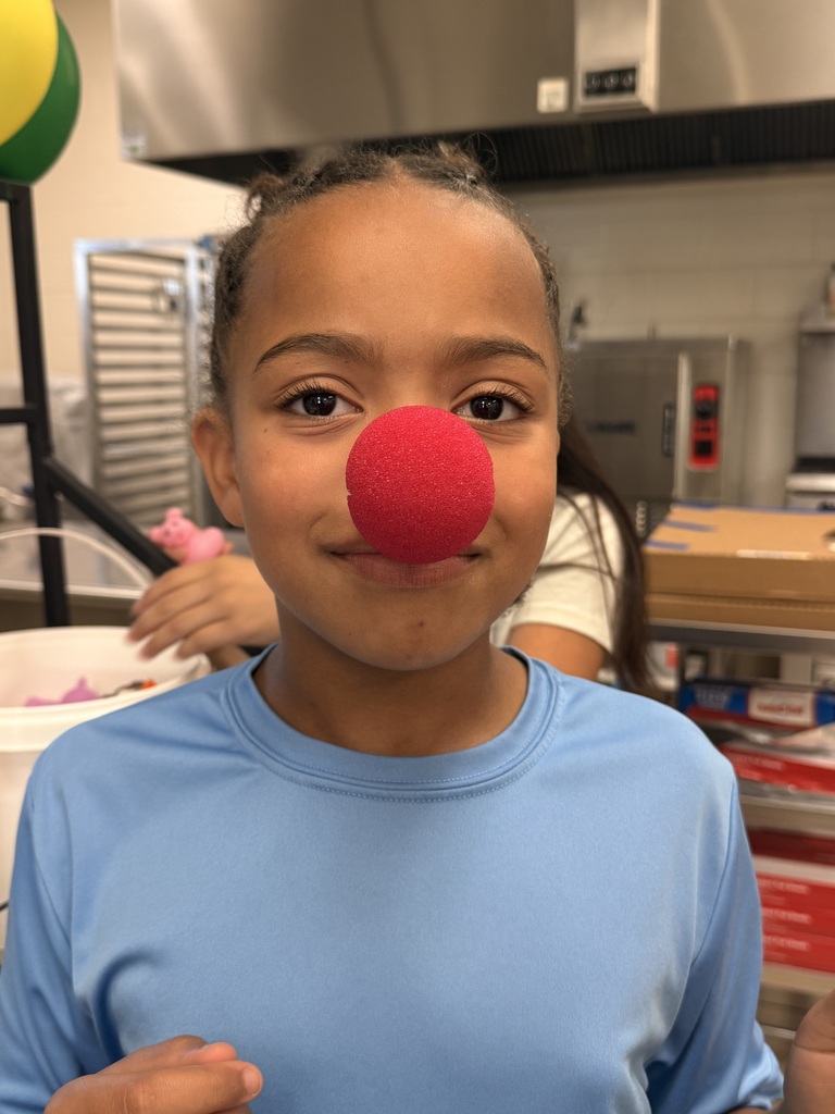 little girl wearing clown nose