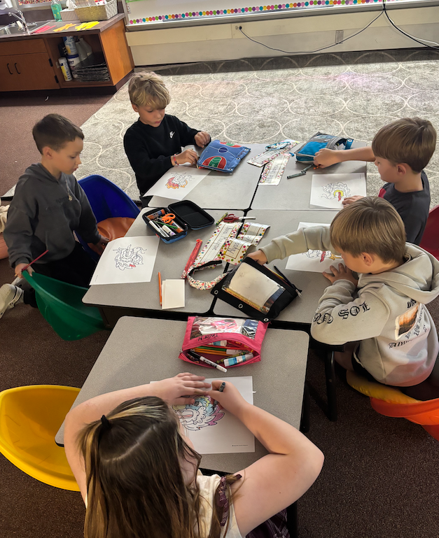 group of kids at desk working on chinese characters