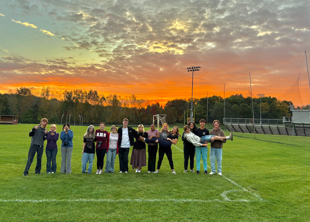 group of kids outside on field with pretty sunrise