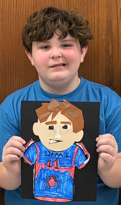 young boy with self portrait art project
