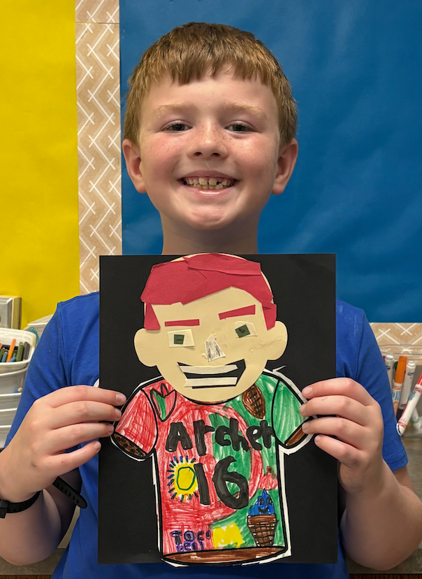 young boy with self portrait art project