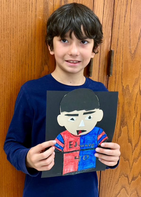 young boy with self portrait art project
