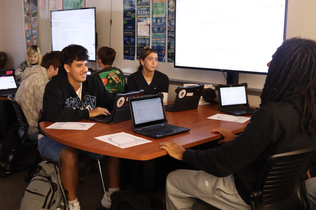 students chatting and working on computers