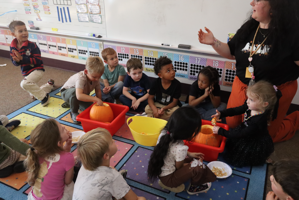 class on floor removing pumpkin seeds from pumpkins