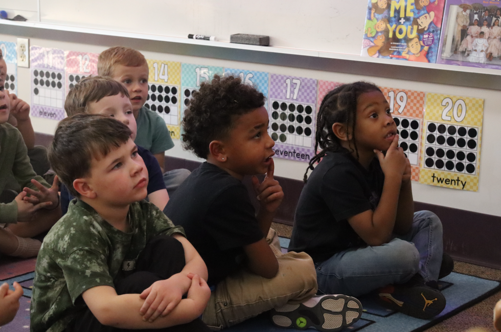 kids sitting on carpet listening to a story