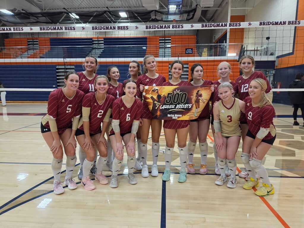 volleyball team holding a banner with 500 assists