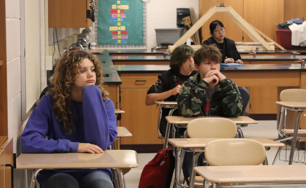 students sitting at desk listening in class