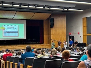 families sitting in auditorium for presentation