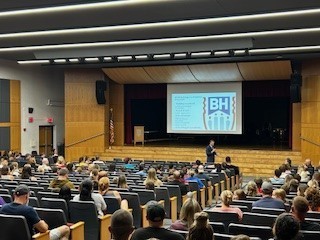 families sitting in auditorium for presentation