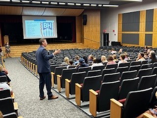 families sitting in auditorium for presentation