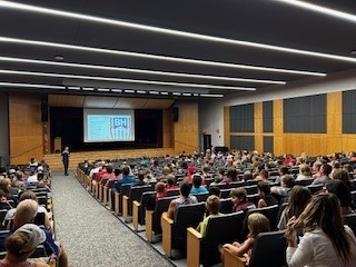 families sitting in auditorium for presentation