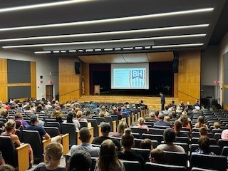families sitting in auditorium for presentation
