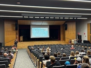 families sitting in auditorium for presentation