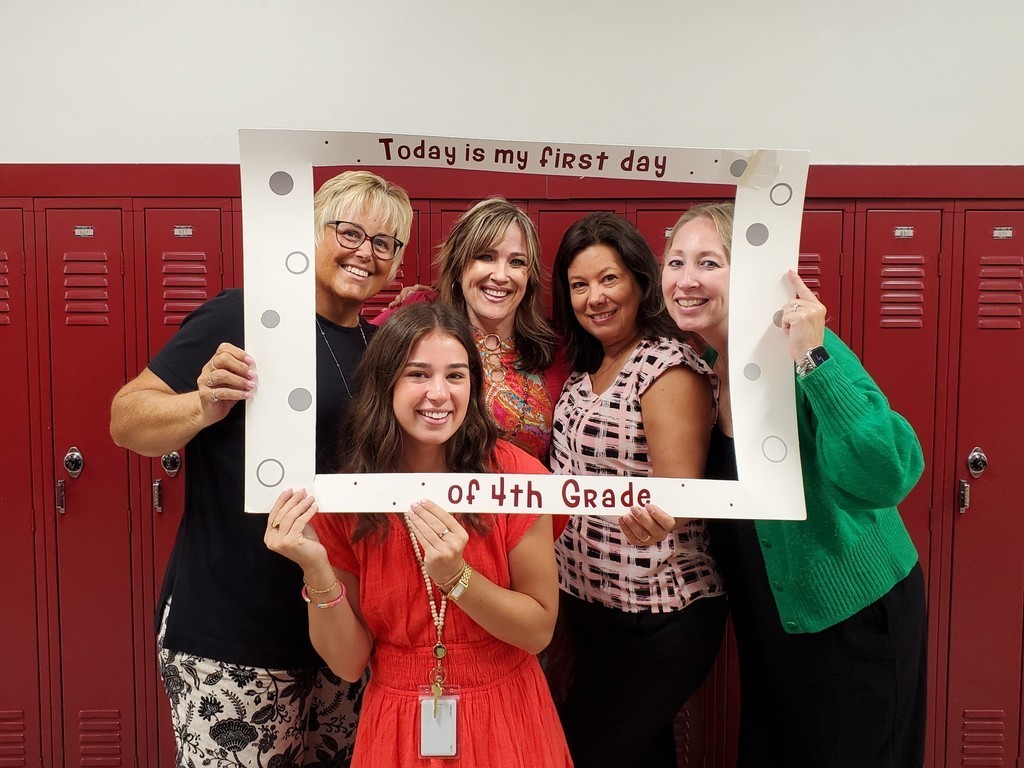 teachers posing with first day sign