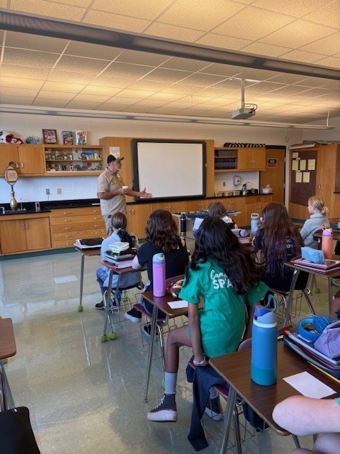 6th Grade students explore some artifacts with Archaeologist Dan!