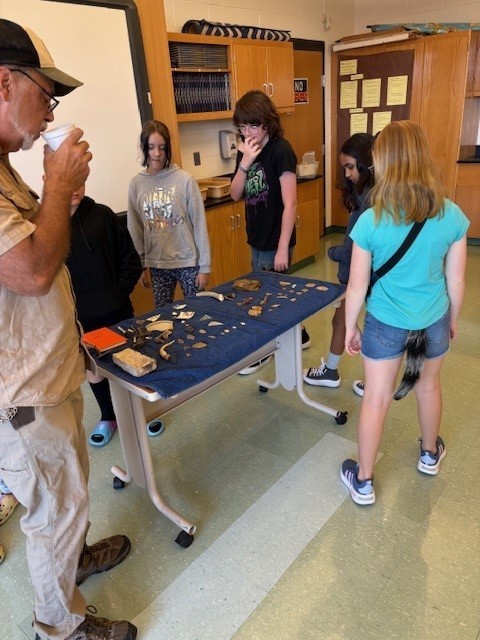 6th Grade students explore some artifacts with Archaeologist Dan!