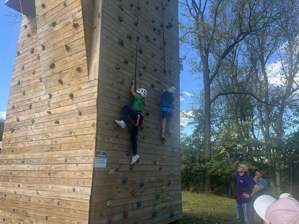 two students on the climbing wall