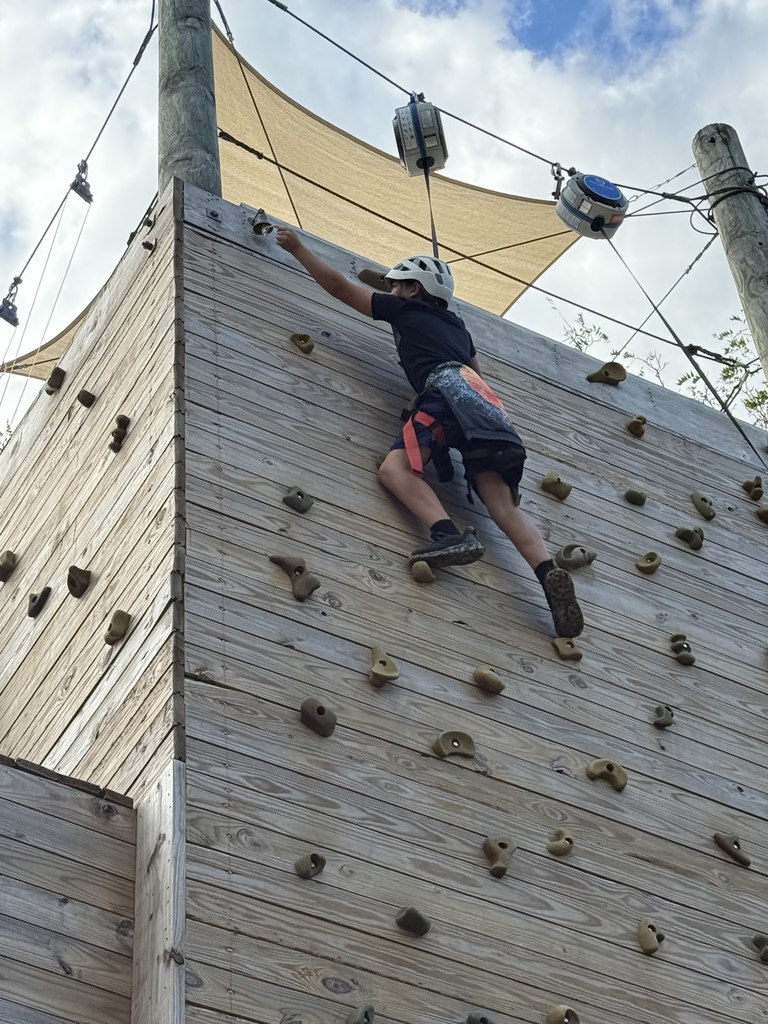 student on the climbing wall