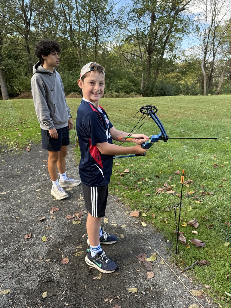 student preparing to shoot a bow and arrow