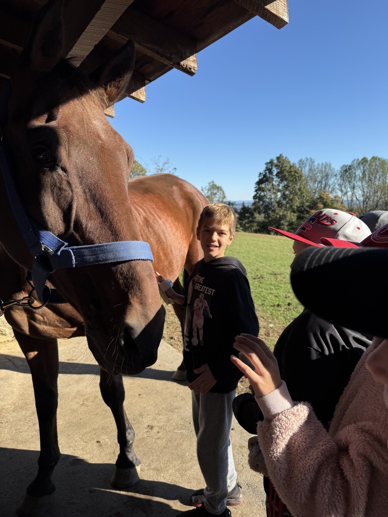 student standing with a horse