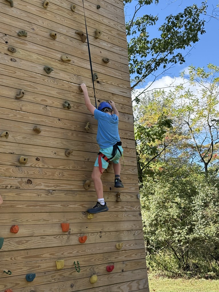 student on teh climbing wall