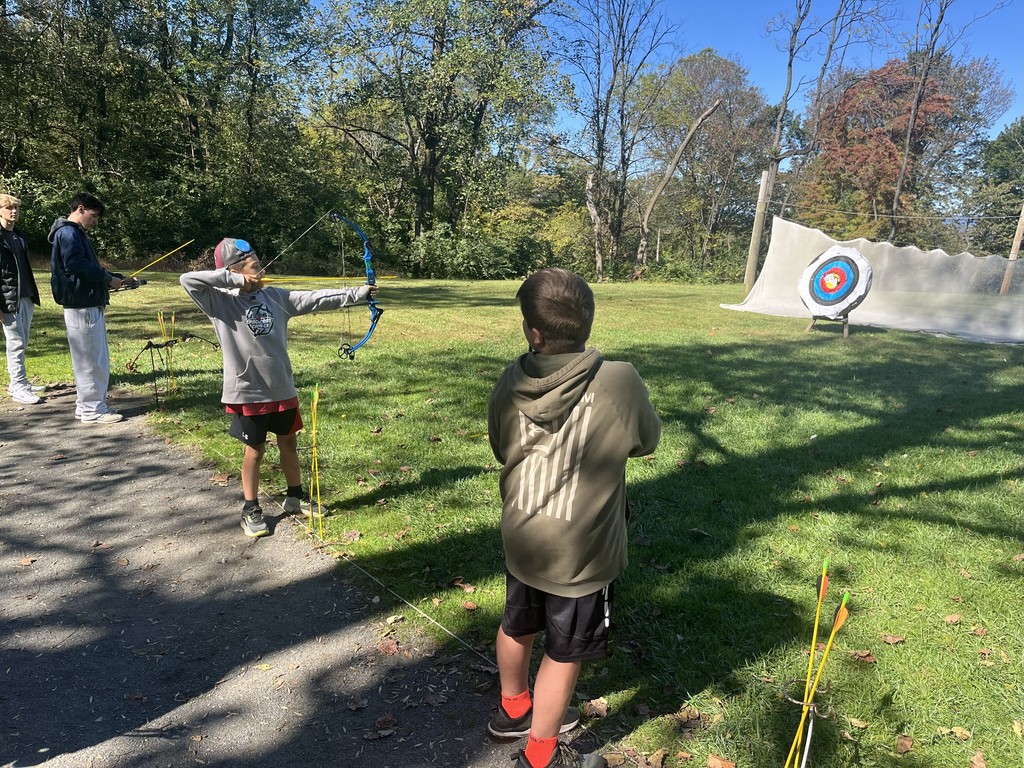 student shooting archery