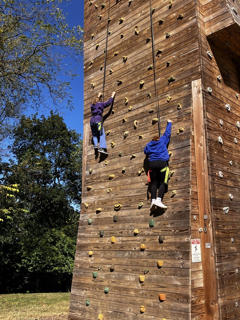 two students on a climbing wall