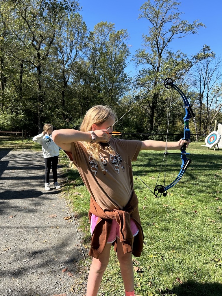 student shoots a bow and arrow
