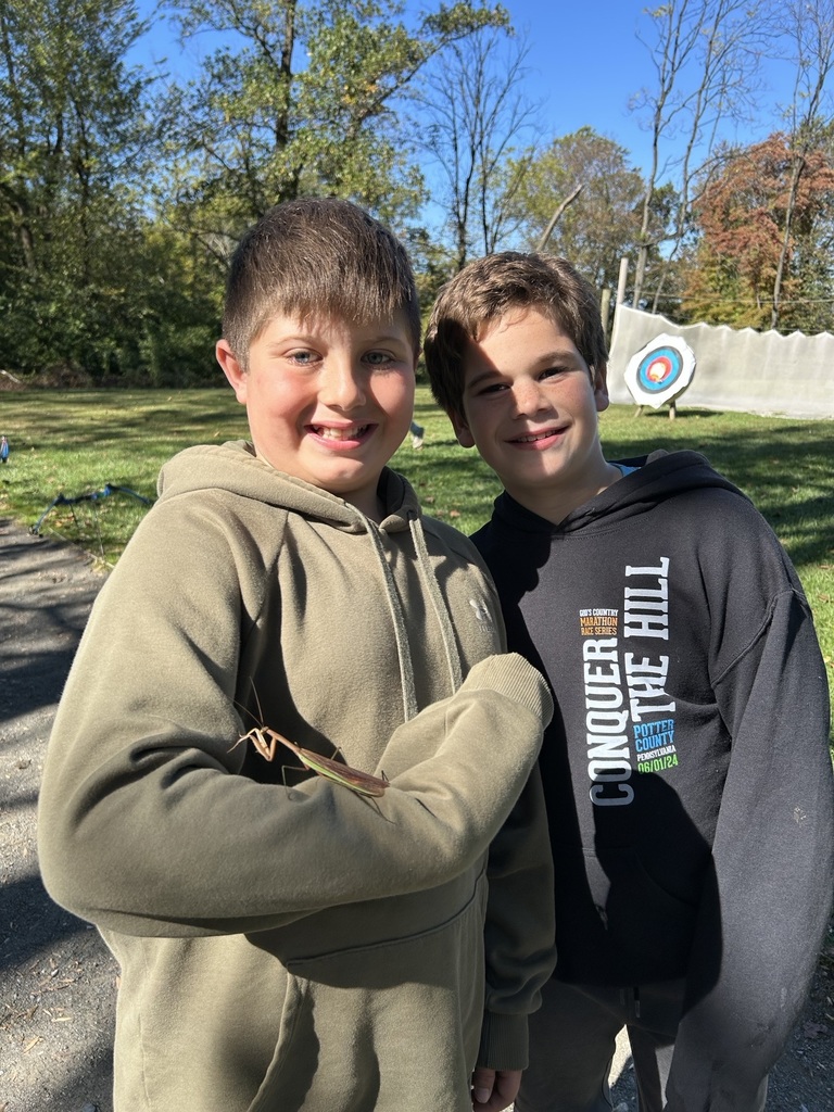 students stand together with a praying mantis