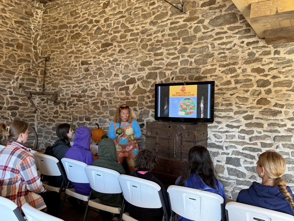Mrs. Savidge teaches about pumpkin farming.