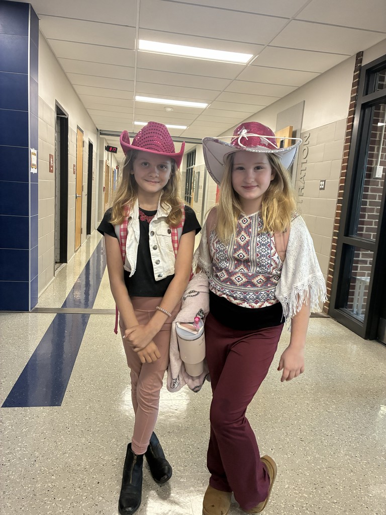 two cowgirls stand together