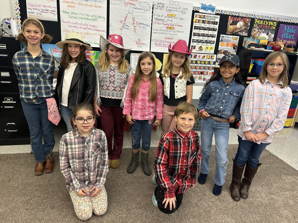 9 students in western gear stand together.