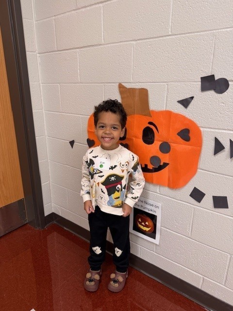 student with pumpkin