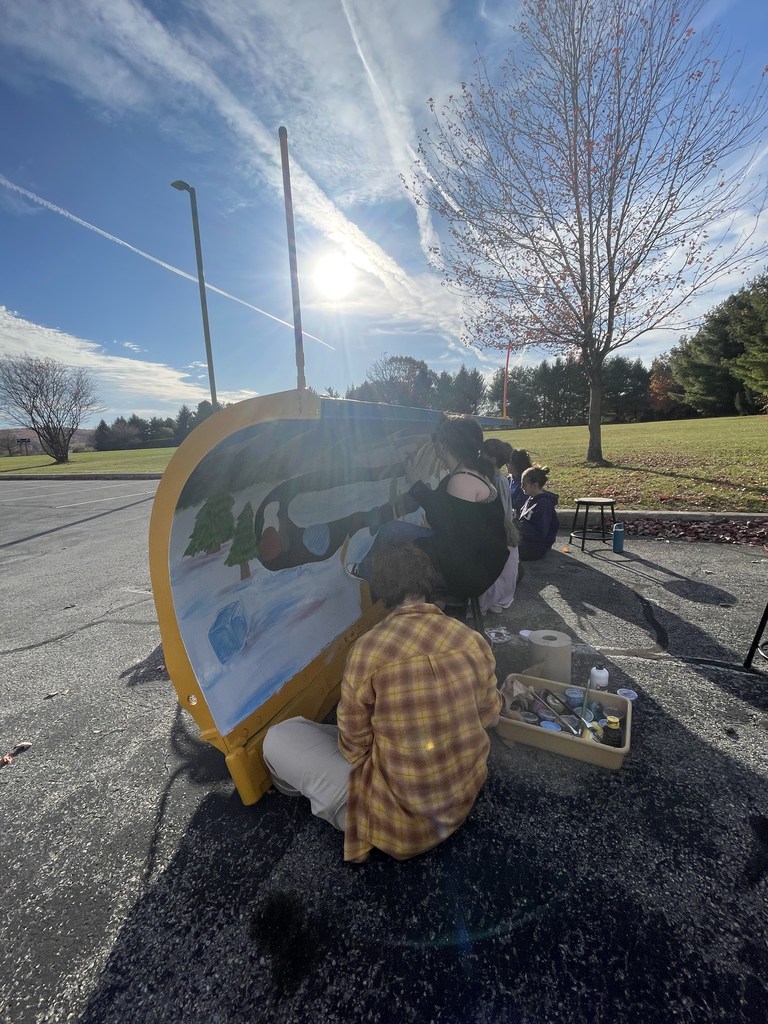 students working on the plow