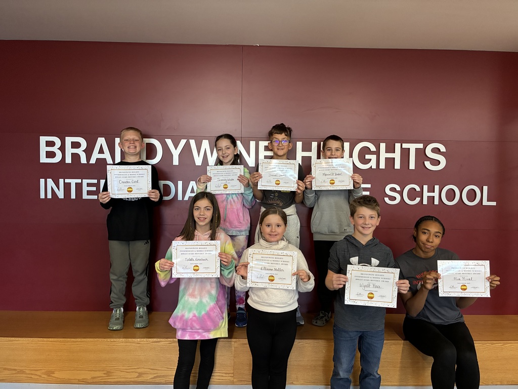 students stand with certificates