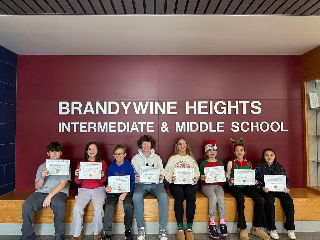 student sit with certificates