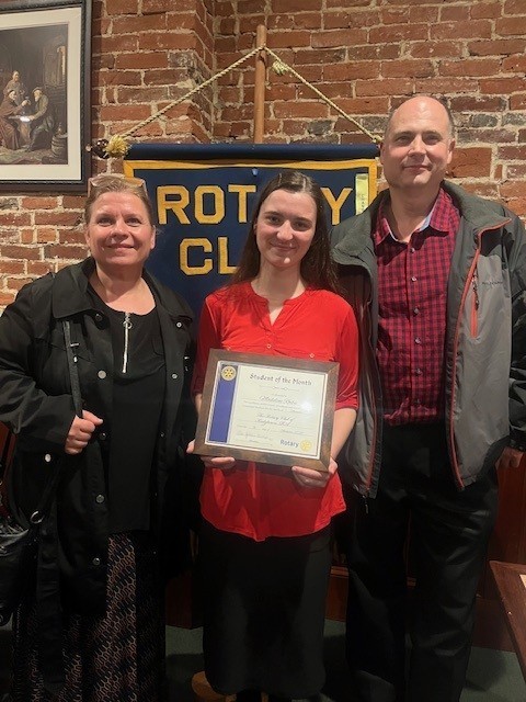 Madeline Roibu and her parents accepting her award.