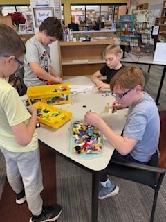 students build with legos at a table